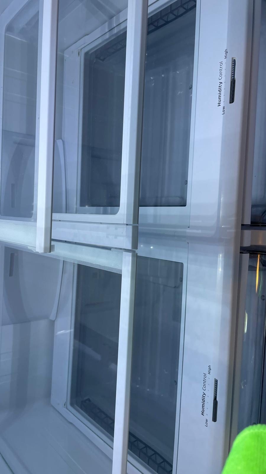 The same refrigerator drawers and shelves cleared and wiped down.
